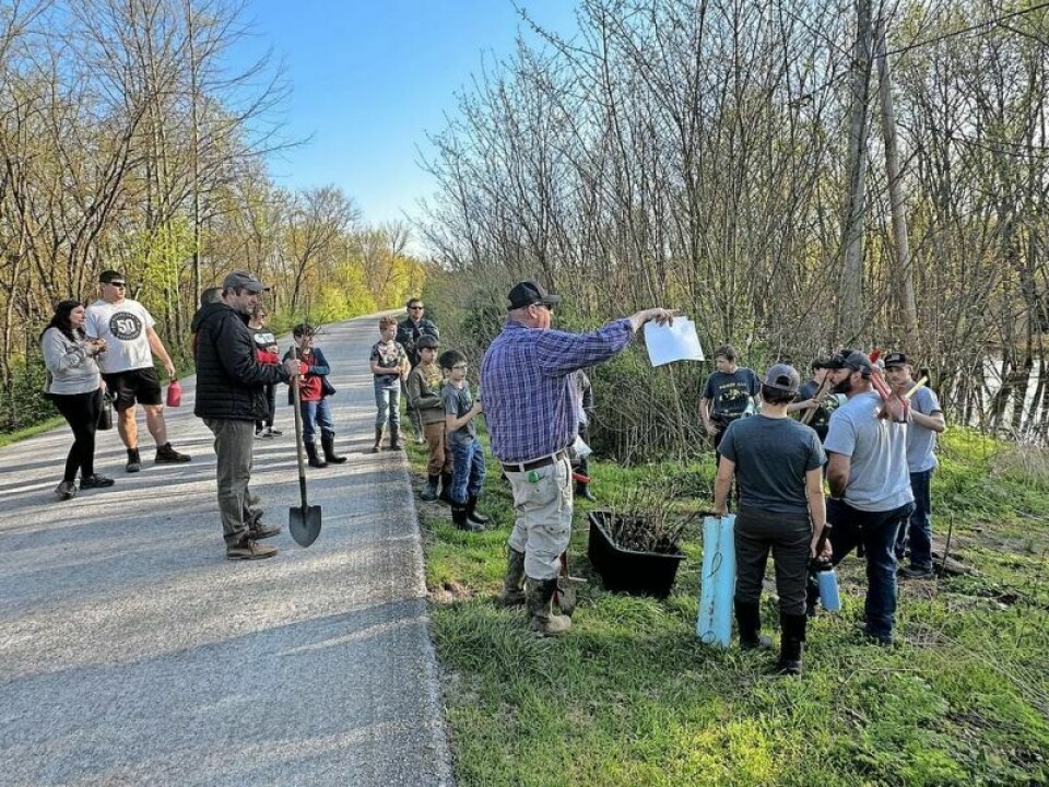 Trevor Berger, Holmes County Soil & Water Conservation District director, explains which trees go into which portion of the swamp along the Holmes County Rails to Trails near Walmart in Millersburg. Scouts unite on Earth Day for annual tree-planting effort