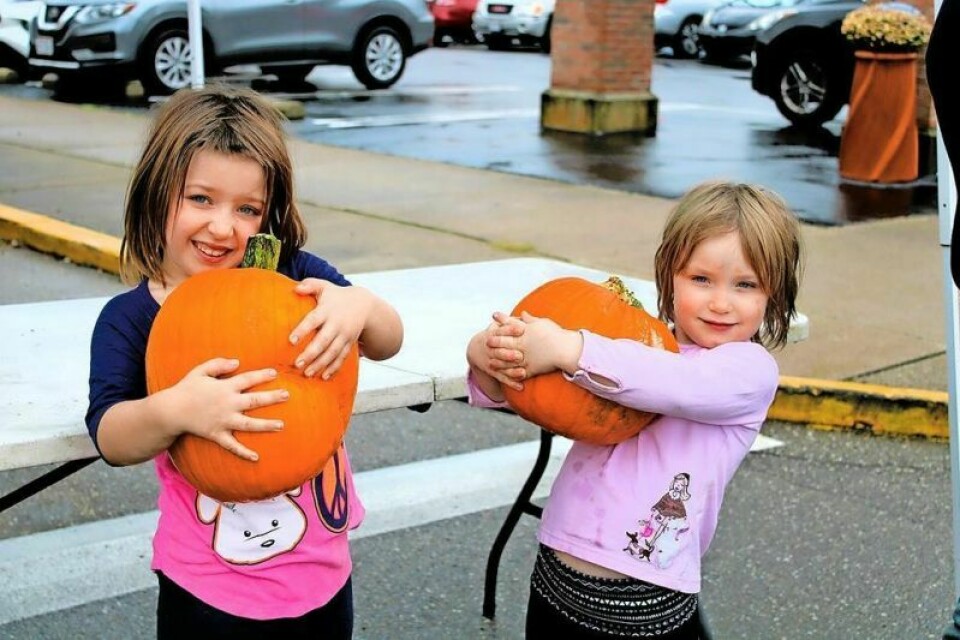 Sisters Sophia, 6, left, and Zoey Summerfield, 5, were thrilled with the pumpkins that were given away at the 2023 Twin City Fall Festival. Twin City Fall Festival is Oct. 12