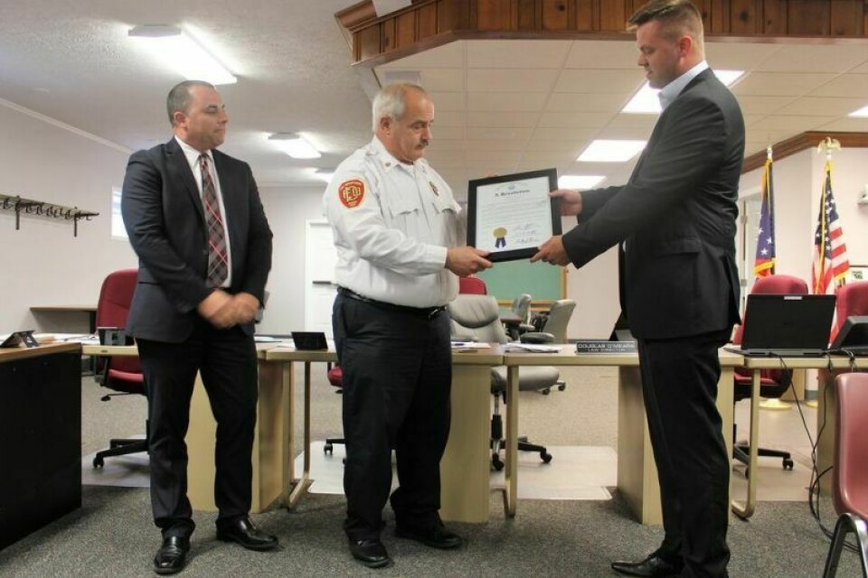 Fire Chief Russ Volkert receives a resolution from State Rep. Brett Hillyer congratulating the Dover Fire Department on 150 years of service. Dover Council discusses litigation