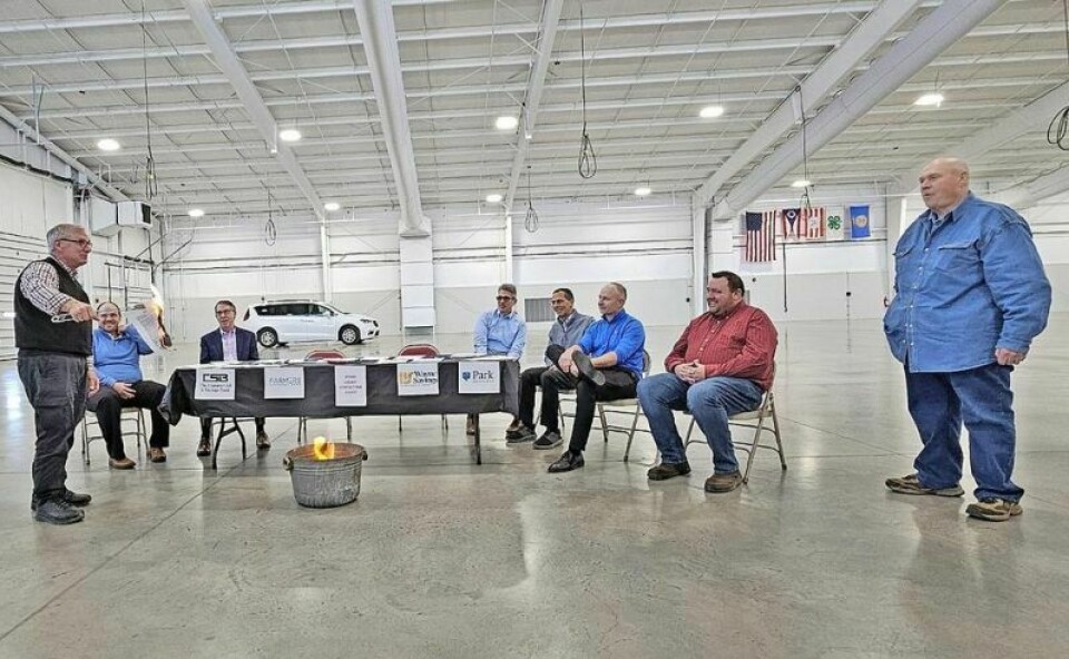 Wayne County Fair Board Director Tom Stocksdale, left, burns the lender note commemorating the final payment of a $1.3 million loan to construct the event center on the fairground. The loan was paid off 15 years early. Fair pays off event center note 15 years early