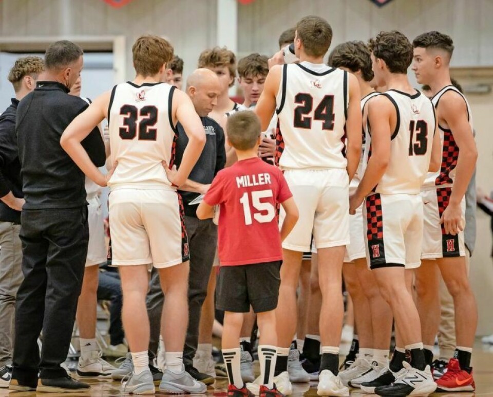 Hiland’s Mark Schlabach, center, was named East District Coach of the Year in Division IV. Several local hoops stars earn All-East District hoops honors