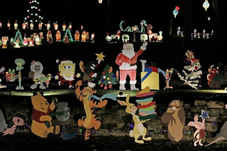 The original waving Santa that started it all in the mid 1970s can be seen at the center of the display. Family collects donations for the homeless shelter