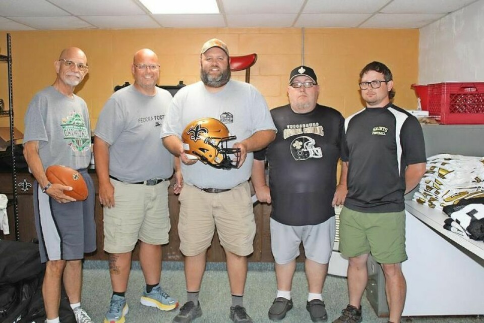 New TCC football coach Giovanni Ionno, center, with assistant coaches Frank Alesiano, left, Ed Korns, Josh Taylor and George Clore. Coaching change and high-tech helmets lead the way