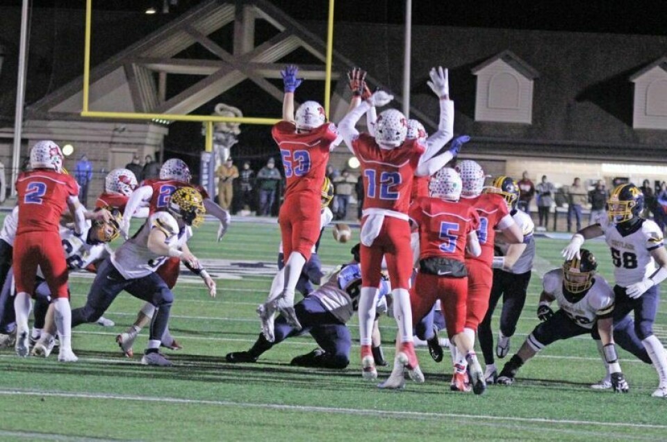 In one of the game's earlier defining moments, Garaway's Clayton Downs, 53, leaps high into the air to block a field goal attempt to keep the game scoreless. Pirates' record-breaking campaign comes to end