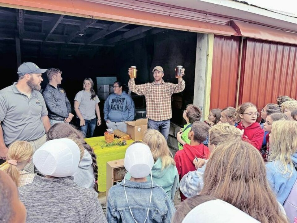 Jeff Pendlebury, holding two honey samples, and his father-in-law Jim Croskey have set aside several acres at DalRoy Farms, where they have put close to 20 hives of bees to work to enhance their crops. Bees a powerful ally in the farming community
