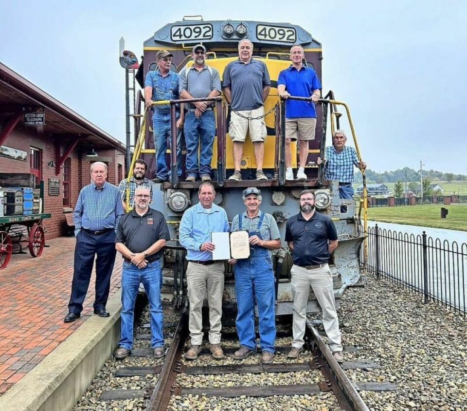 Individuals from the Age of Steam Roundhouse Museum, The Genesee & Wyoming Ohio Central Railroad, and the Monongahela River, Railroad and Transportation Museum gathered at the Age of Steam Roundhouse Museum for the donation of diesel locomotive, GE B23-7R 4092. Age of Steam Roundhouse receives diesel locomotive