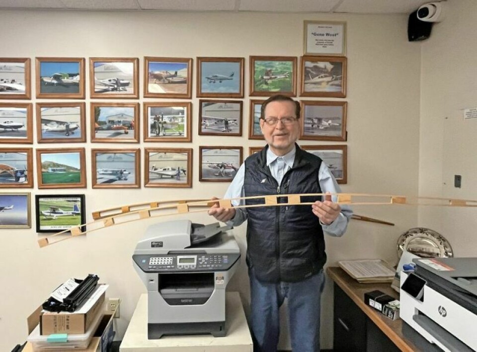 Terry Henry, Wright Flight coordinator, holding a replica of a 1905 Wright Flyer wing rib students in the class can make and take home. Wright Flight lets students earn their wings