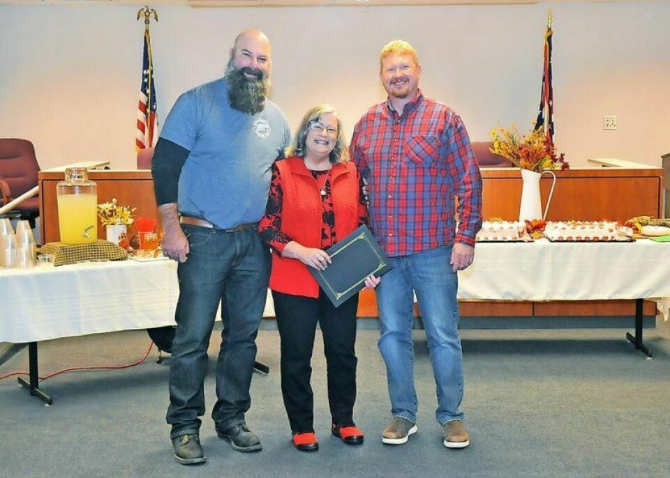Darcy Becker, center, poses with Wayne County Commissioners Dave McMillen, left, and Jonathan Hofstetter after they presented her with a proclamation on her retirement from the Ohio State University Extension as a Supplemental Nutrition Assistance Program coordinator. Becker retires after nearly 17 years with OSU Extension