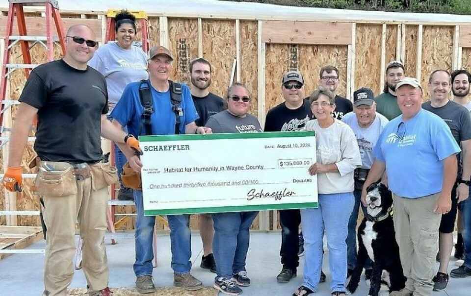 Chris Shamie, left, of Schaeffler presents a check for $135,000 to Habitat for Humanity Wayne County Executive Director Beth Weaver, shown here with others at the site of the HBH home on Williams Way in Wooster made possible through the donation. Schaeffler donation makes Habitat home possible