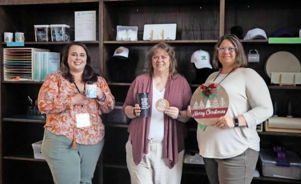 Library employees Leigh Burnham, left, Robyn Guedel and Erin Snider pose with items created using the county library’s MakerSpace equipment. County library’s MakerSpaces get new equipment
