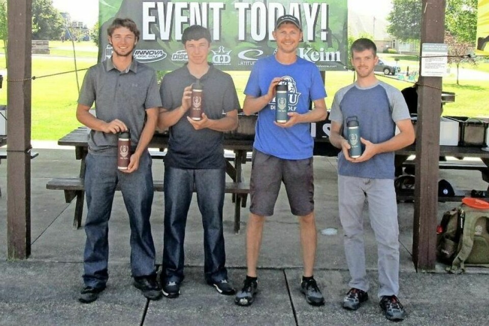 Justin Steiner, third from left, and Joe Yoder, far right, won the Holmes County Disc Golf Club doubles tournament on July 27 at Deer Run Park in Millersburg. The winners edged Matthias Hilty, left, and Alan Hilty by a stroke. HCDGC holds doubles tourney at Deer Run