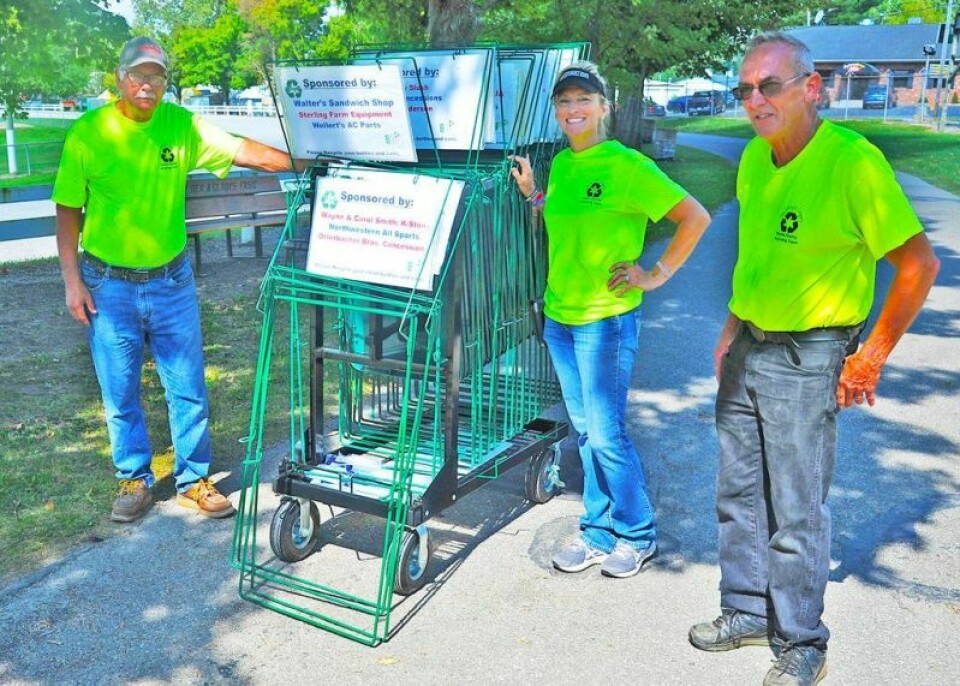 Ray Leisy, left, Kelly Riley, and Tom Dilyard spent the day installing recycling bins throughout the fairgrounds recently. Leisy’s Legacy continues recycling efforts at fair