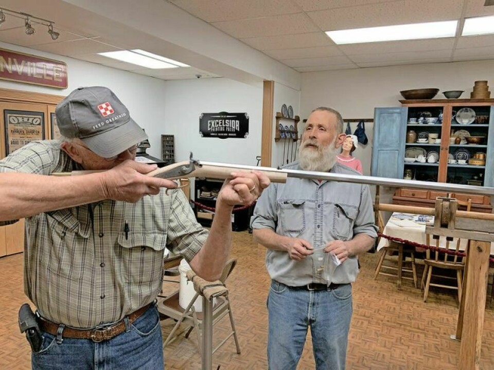 Steve Hughes, left, handles the rifle, still under construction, as instructor Tom Oakes looks on. The Cleo Redd Fisher Museum will offer the chance to win the hand-built blackpowder rifle in a raffle, with the drawing on Jan. 13. CRF Museum to hold raffle for hand-built muzzleloader