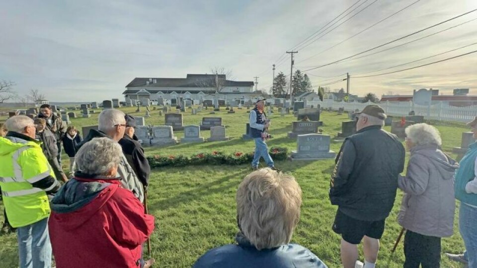 Noel Vander speaks about the importance of Wreaths Across America to a group at St. John’s Cemetery on Dec. 16. Vander has developed a special relationship with a family in Maine whose son was killed while serving just one month into his time in Iraq. A story far too familiar brings Vander, Maine family close