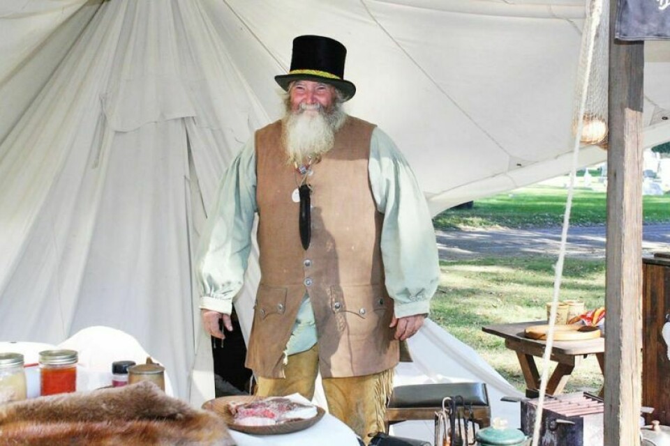 Tim Rohr, aka Mountain Man of Canal Fulton, dons a new top hat at the encampment for Apple Butter Days in 2022. Apple butter to be made at Gnadenhutten