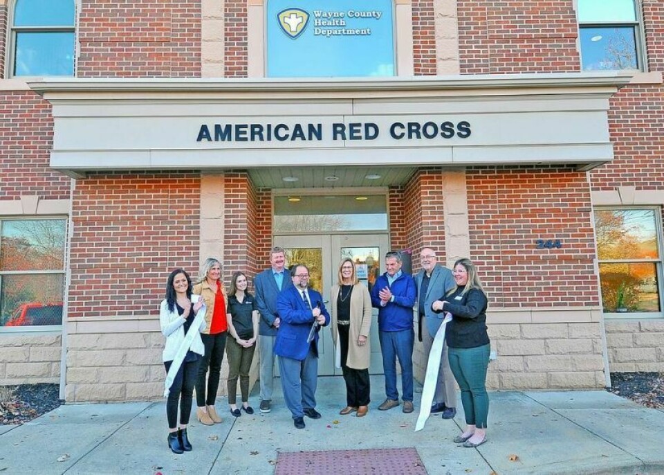 Health commissioner Nick Cascarelli cuts the ribbon in front of the door to the new location of the Wayne County Health Department in the Red Cross building at 244 W. South St. in Wooster. Looking on are Wooster Chamber President Samira Zimmerly, left, Kimberly Kroh and Elizabeth Cante of Red Cross, commissioner Jonathan Hofstetter, commissioner Sue Smail, community liaison Steve Matthew, commissioner Ron Amstutz, and Orrville Chamber marketing and communications representative Landre McCloud. Health department opens at new location in Wooster