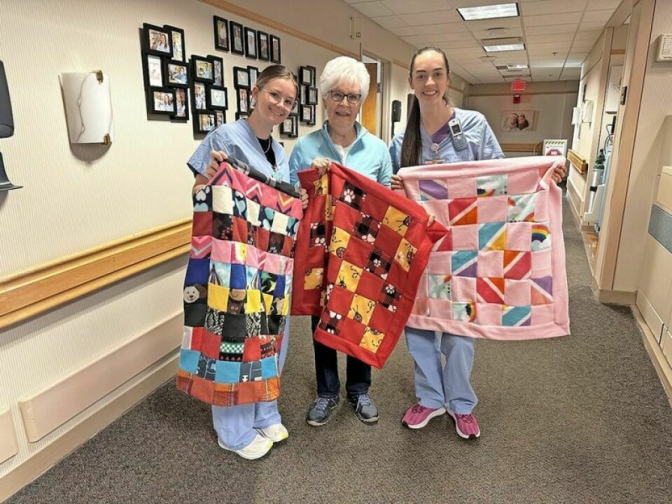 Pomerene Hospital nurses Fallon Miller, left, and Olivia Coblentz celebrate another delivery of baby blankets from St. John’s Women’s Ministry with group member Sue Banbury, who started this blanket ministry years ago in her basement. St. John’s women’s group blankets others in warmth