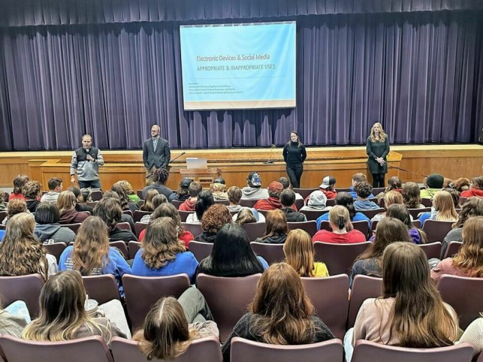 While West Holmes High School Principal Scott Pringle addresses the sophomore class at the recent Positive Digital Imprint Seminar, keynote speakers Matthew Muzik, Holmes County prosecutor, left; Julie Dreher, magistrate in the Holmes County Juvenile Court; and Rachel Cornell, probation officer with the Holmes County Juvenile Court, wait their time to promote safe and healthy social media practices. WHHS Positive Digital Imprint Seminar designed to educate