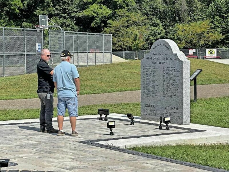 Brothers Dean and Rene Weber admire the monument listing Holmes County members who served and gave their lives or were prisoners of war. The new monument is located on Glen Drive in Millersburg. Veterans humbled to purchase benches honoring those KIA