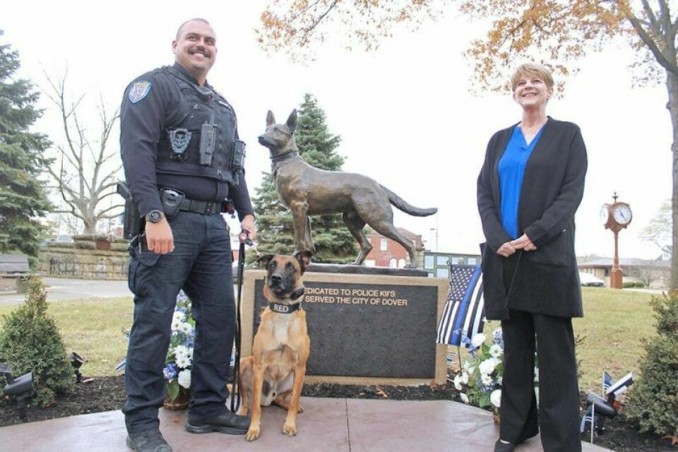 K-9 handler Jordan Doughty, left, K-9 officer Red and Dover Council member Sandy Moss with the new memorial to Dover's K-9s. Dover unveils new K-9 officer memorial