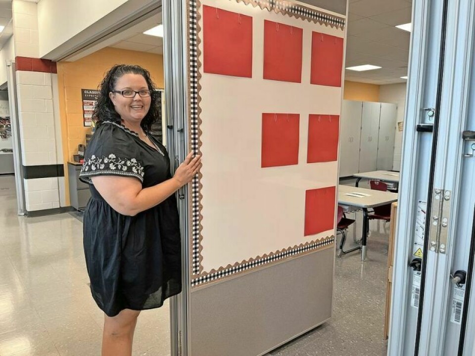First-grade teacher Nikki Nazaroff demonstrates how partition dividers that form the outer wall of the classrooms feature whiteboards and magnetic boards on the opposite side. Tusky Valley officially opens new elementary school