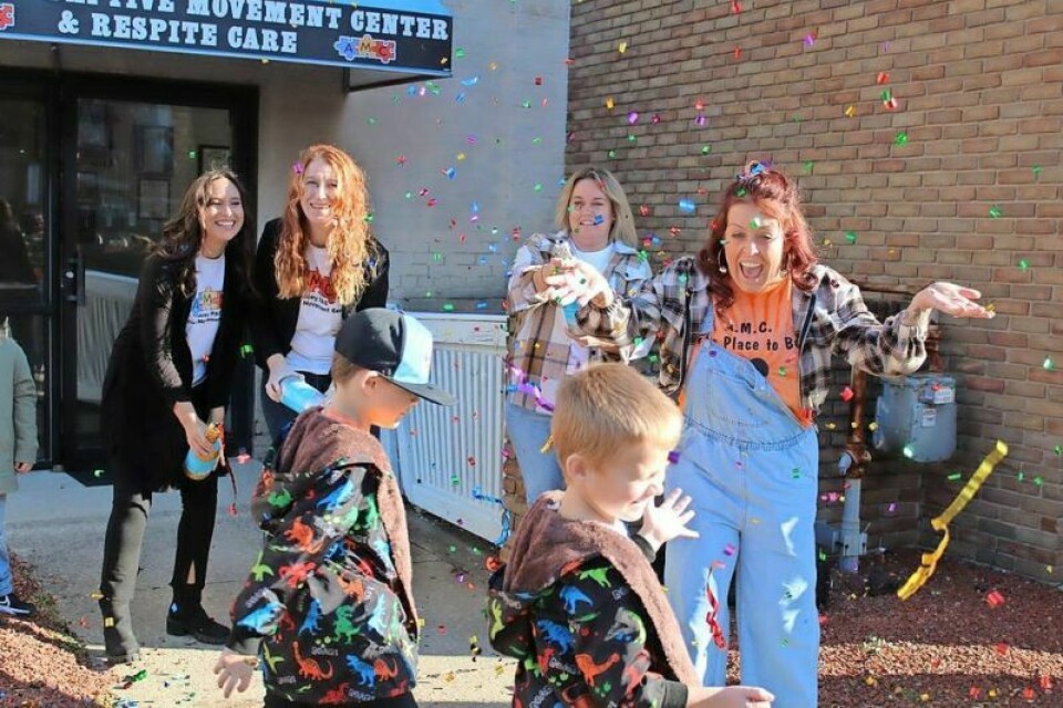 Lacey Herbert-Stephens celebrates the opening of a new Adaptive Movement Center with her sons, Jett, left, and Cash. Lacey PAC Adaptive Movement Center in new location
