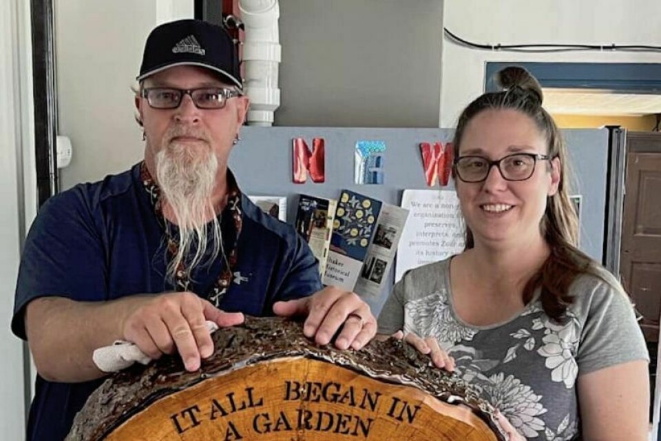 New Philadelphia resident Steve Plaso presented a section of the Tree of Life to Tammi Shrum, site director for Historic Zoar Village. Artist present gift to Zoar