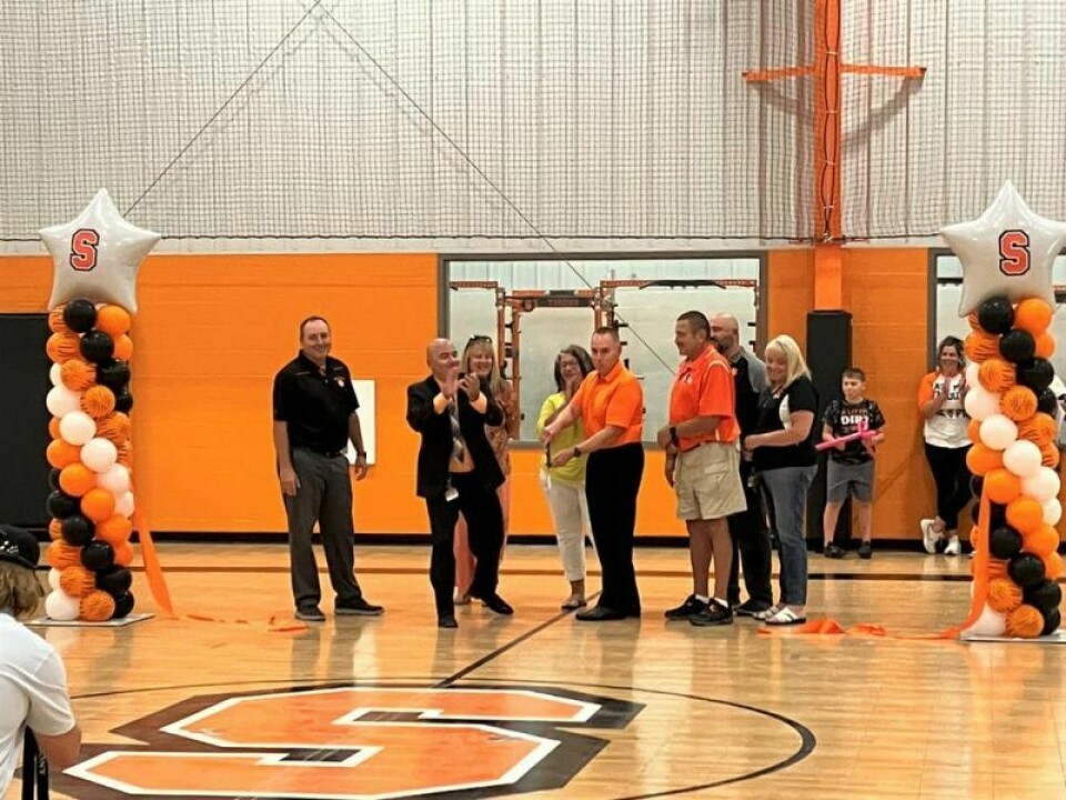 Athletic Director/Dean of Students Gary Spinell, left, Superintendent Vince Lindsey, Board President Kevin Harvey, board member Wes Hostettler, Elementary Principal Shelia Doerschuk; rear, board member Stacy Bitikofer, board member Diana Flickinger and High School/Middle School Principal Frank Kruger Ribbon cutting and dedication for multipurpose building