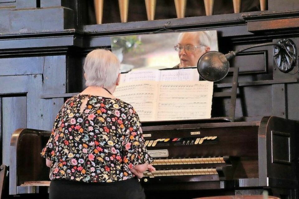 Organist Jane Hughes plays the organ during Sunday services. Church replaces original roof more than 150 years later