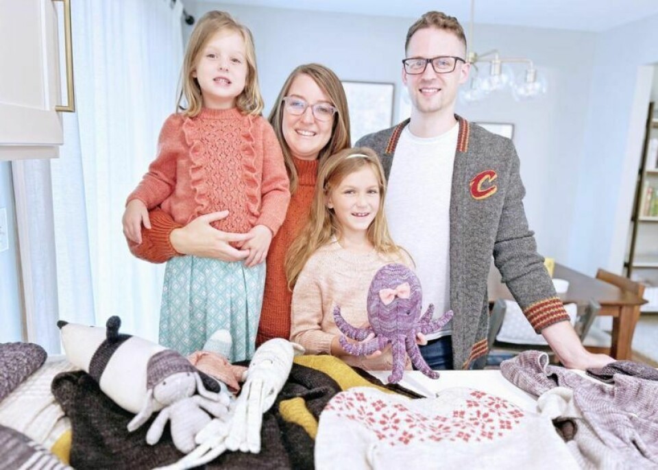 Marcus Hartzler knitted clothes for his family to enter in the Wayne County Fair Arts and Home Economics Department including a cardigan for himself and sweaters for daughter Claire, left, wife Karma and daughter Eva. Displayed in front of them are more of Hartzler's projects. Hartzler's knitting formula has been a proven winner