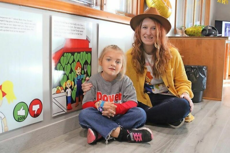 Ruby Sue Kline and area author Farrah Raines sit near the new story walk inside the Tuscora Park Place Youth Center. Story walk added at Tuscora Park Place Youth Center
