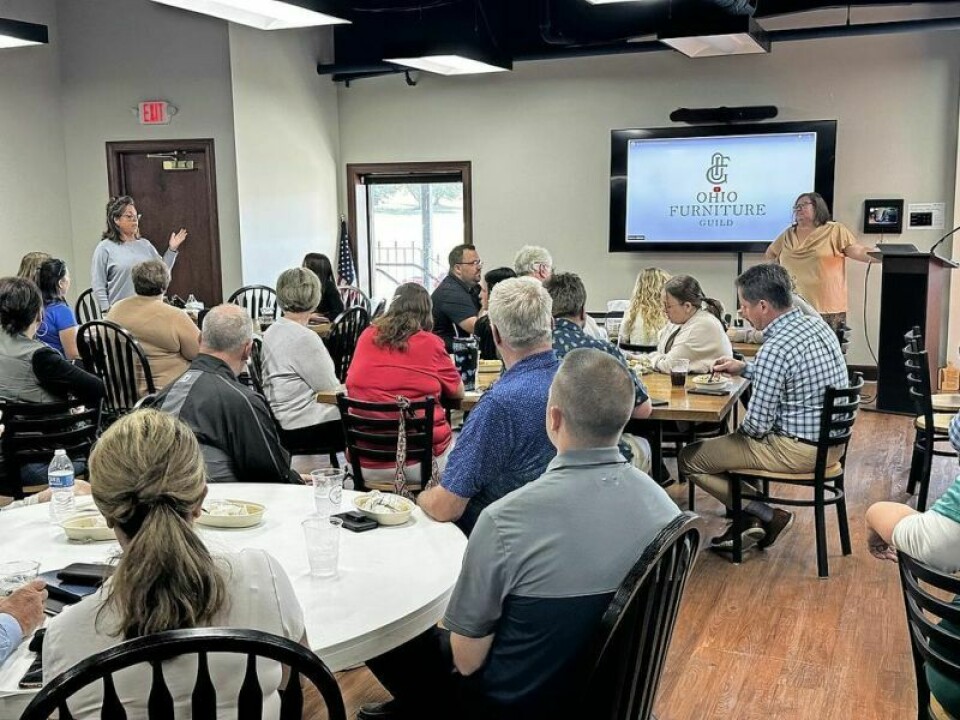 Jennifer Fecht, standing far left, the new tourism marketing manager with the Holmes County Chamber of Commerce & Tourism Bureau, speaks at a recent chamber event. Fecht eager to get busy as new chamber marketing manager