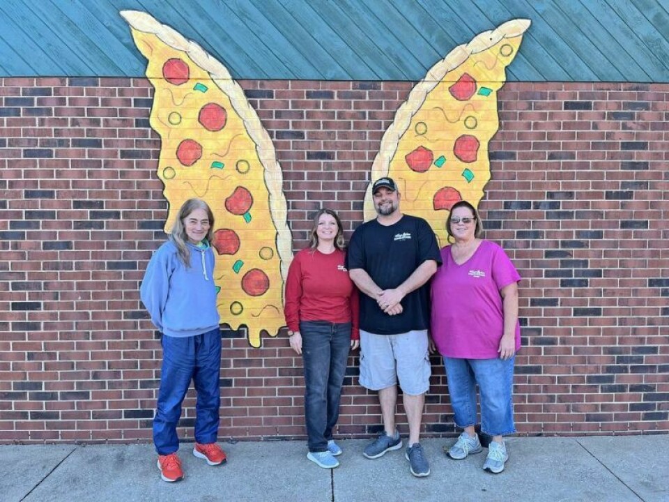 Mary Zifer’s Pizza in Dover is sporting a new mural. The pizza wings design was painted by local artist Teresa Prince, left. Also pictured are Kelly Gintz, Josh Gintz and Patty Gintz, who co-own the business. Mary Zifer’s gets a facelift ... and wings