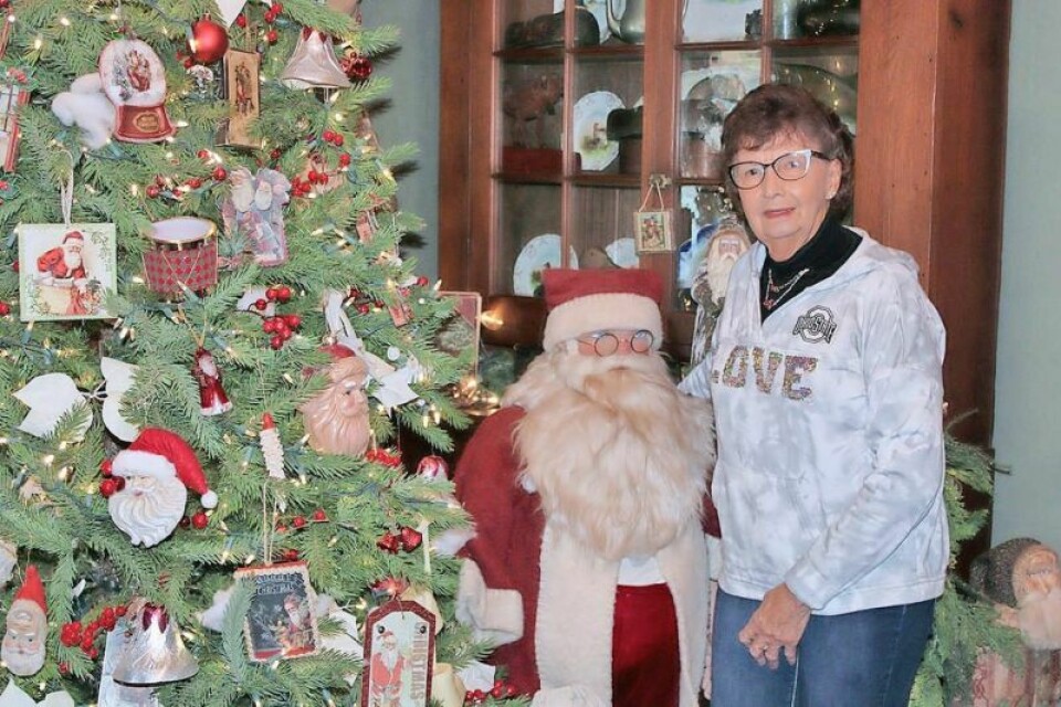 Karen Mortimer of Port Washington with Santa. Mortimer helped her sister Nancy Hunter decorate at the Hunter Farmhouse. Hunter Farmhouse is one of featured stops on Tour of Homes
