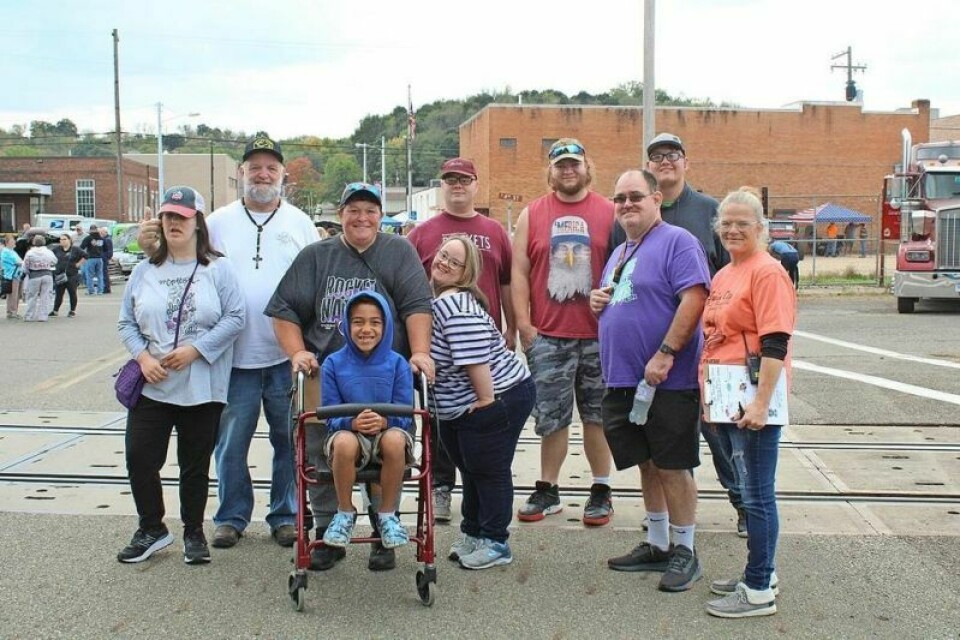 A group of Special Olympics athletes and volunteers at the Twin City Fall Festival car show. Pictured are Carol Snyder, left, Patrick Snyder, Tonya Ross with Julius Emery, seated, Tyler Ross, back, and Emily Erwin, front, Aidan McClain, Brian Wedlake, Kadyn Cook-Linamen, and Jamie Randolph. Special Olympians shine as car show judges at fall festival