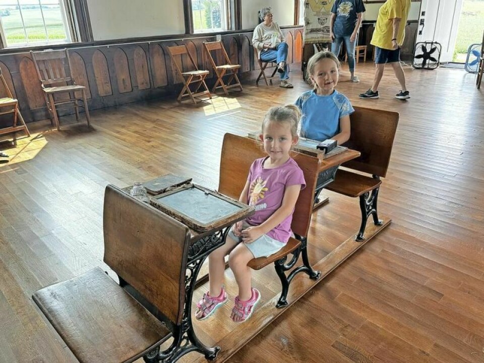 Hadley, front, and Beatrice Crone sit at the two small wooden school desks now located inside the Oak Grove One Room Schoolhouse. Hadley’s desk is believed to be an original from the old school that was rebuilt by Jim and Shirley Croskey on their farm. How the 1-room Oak Grove School was lovingly restored