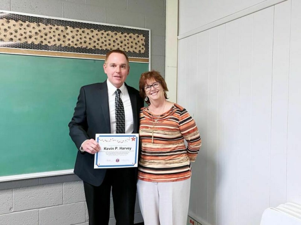 Strasburg Board of Education President Kevin Harvey receives a training award from Sally Green, OSBA president-elect. Harvey receives a training award from OSBA president-elect