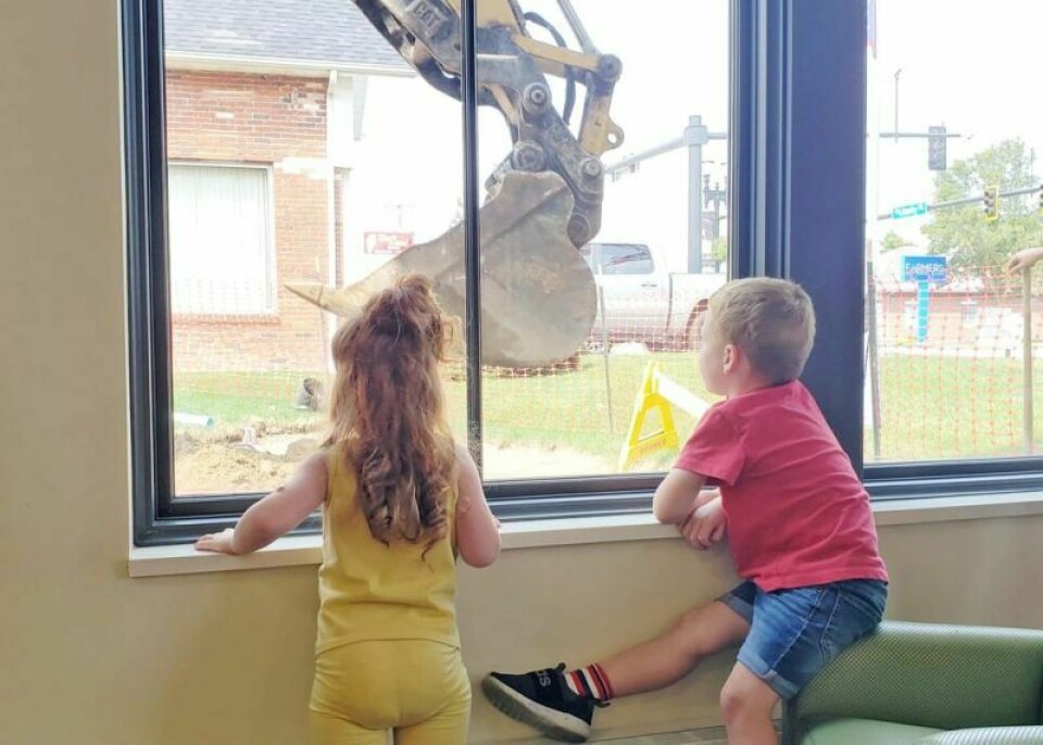 Two youngsters watch the excavation of the garden outside the play area window, part of the on-going renovations at the Wooster branch of the Wayne County Public Library. Library’s Wooster branch begins updates