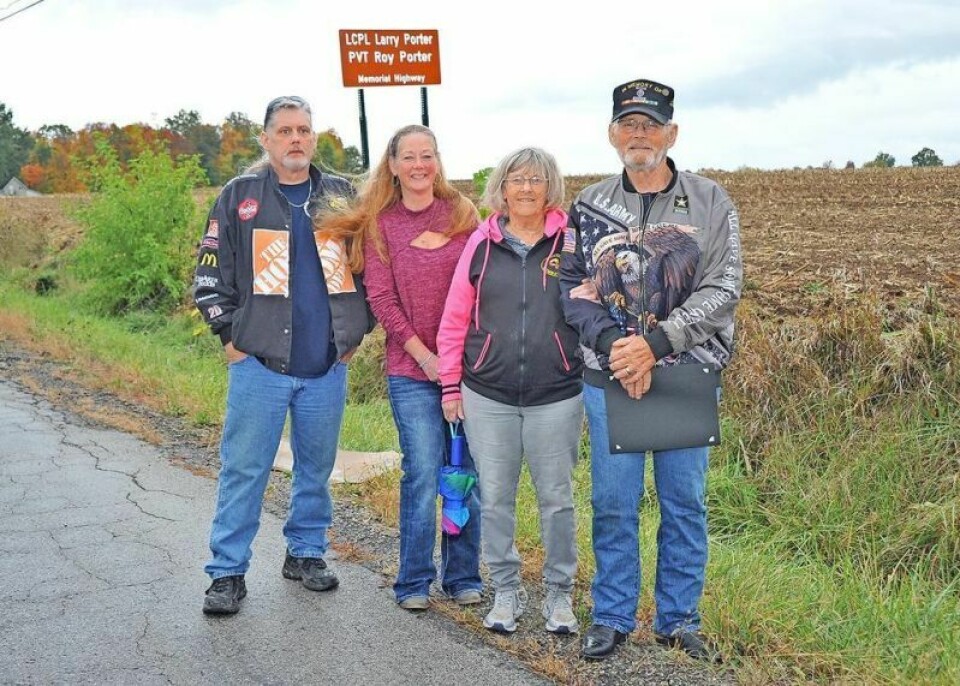 Family members stand near the sign of the newly dedicated road segment, the Pvt. Roy Porter and LCpl. Larry Porter Memorial Highway. In attendance were nephew Roy Porter, left, niece Laura Beckelhimer, sister-in-law Dotty Porter and brother Jerry Porter. Dalton brothers KIA in Vietnam are honored