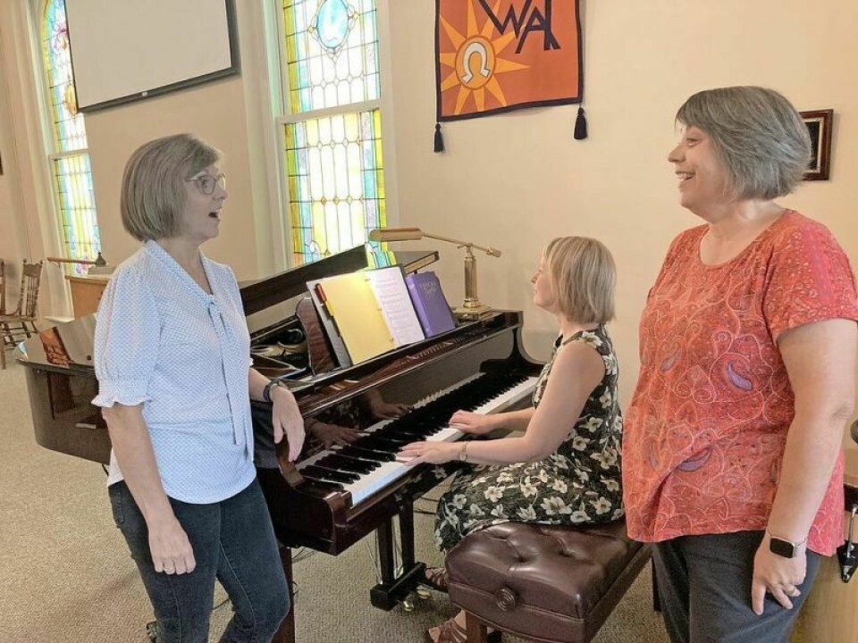 Georgia Jaeb, left, and Marianne Mader practice some warmups with Rachelle Lyndaker-Schlabach at the piano. The trio is starting the Sing for Joy Chorus, a free community choir open to individuals and their loved ones navigating memory loss. The 10-week choir will begin Sept. 10 at Millersburg Mennonite Church. The deadline to register is Sept. 8. Memory-loss-related choir to start meeting soon