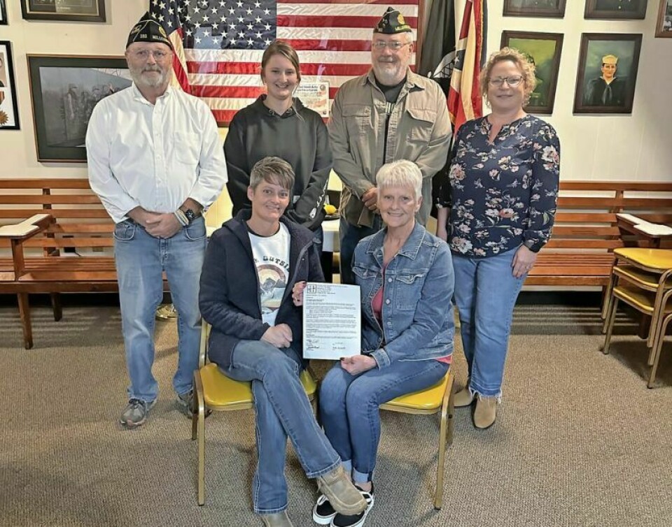 Jen Miller, seated left, daughter of Karen Shaffer, seated right; Craig Lawhead, commander of the American Legion Holmes Post 192, left, standing; Saylor Miller, granddaughter of Karen Shaffer; Post 192 manager Wes Maxwell; and Shasta Mast, executive director of the Holmes County Education and Community Foundation, gathered together at the Legion Hall in Millersburg to celebrate and honor Larry Shaffer through a newly created endowment fund. Legion honors Shaffer through HCECF endowment fund