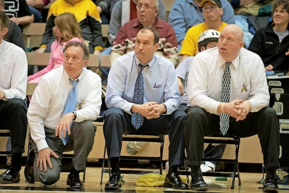 A big part of the success of The College of Wooster men’s basketball team during the tenure of head coach Steve Moore, middle, was 26-year volunteer coach and Holmes County resident Bruce Martin, left. Doug Cline, right, is now the head coach at Wooster. Martin receiving Distinguished Award of Excellence from Wooster