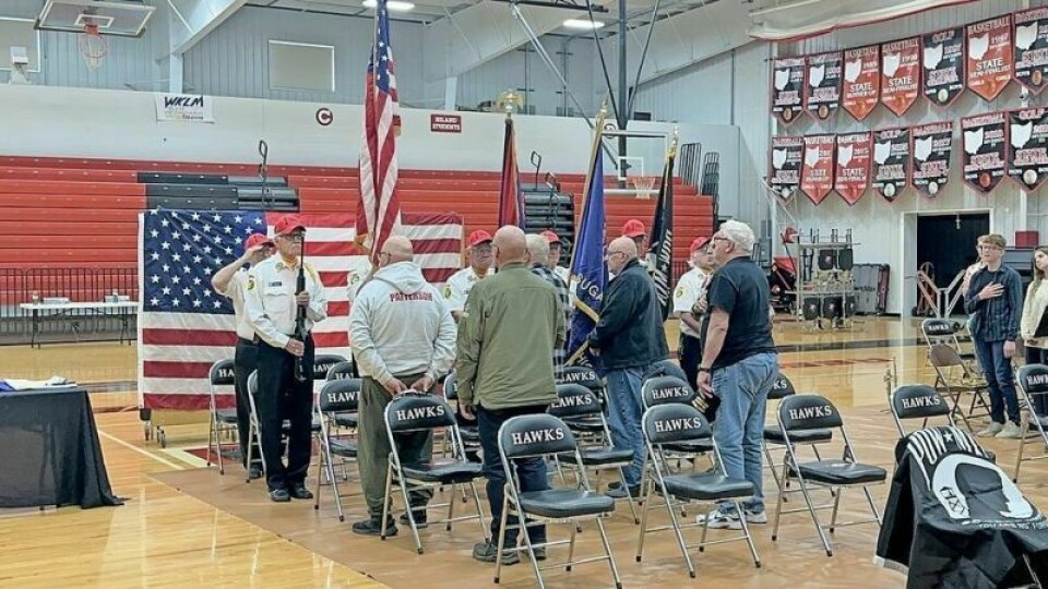 A group of veterans turns their attention to the flag during the playing of the national anthem at the Nov. 11 Veterans Day celebration at Hiland High School. Hiland NHS relishes tradition of honoring veterans