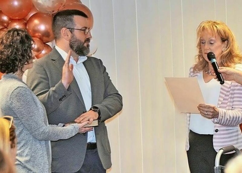 Russell Robertson, left, takes the oath of office from his predecessor Jarra Underwood while stepping into the position of Wayne County auditor. Robertson replaces Underwood as Wayne County auditor
