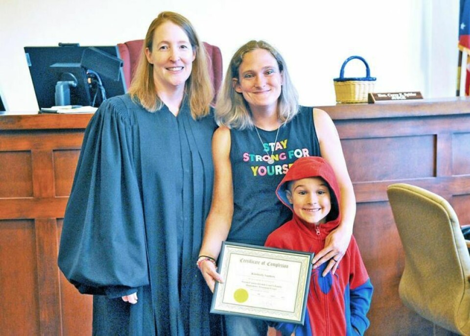 Judge Latecia Wiles, left, poses with recent recovery court graduate Kimberly Sanders and her son Matthew Yoder. After spending two years in the recovery program, Sanders is now sober, has regained custody of her son and is working toward a State Tested Nursing Aide certification. Recovery court helps turn woman's life around