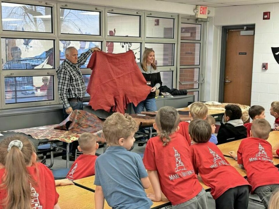 As part of Community Day at Berlin Elementary, Myron Stutzman, left, and Shanda Houston from Weaver Leather brought in nearly 20 different types of leather to talk about with the students, including some exotic leathers. Berlin Elementary Day designed to ‘make school cool’