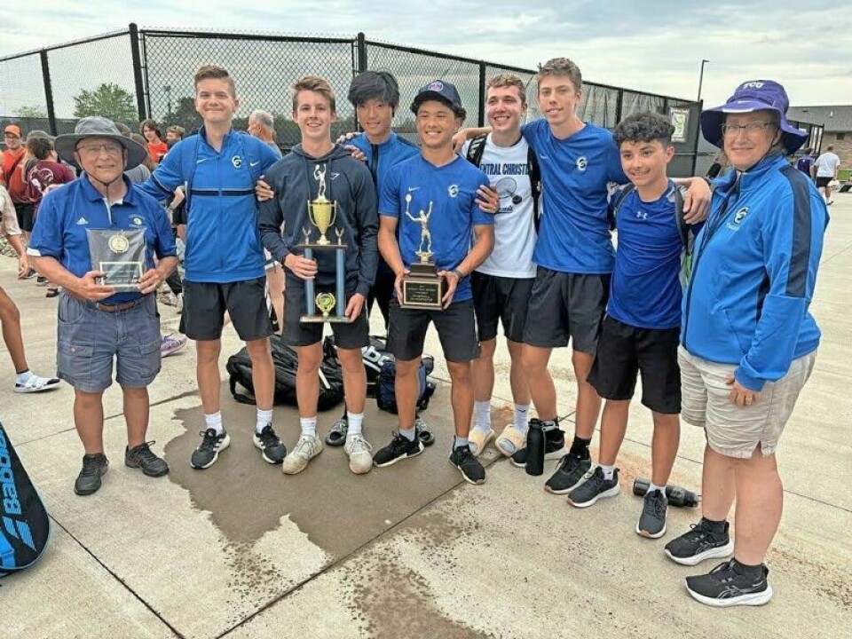 After falling a half-point short a year ago, coach Gene Lehman, left, and the Central Christian boys tennis team took home the hardware this season as the Northeast Tennis Conference champions. Central Christian charges to NET boys tennis title