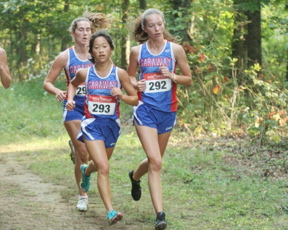 Garaway’s Mya Wengerd, left, and Meghan Schwartz, pictured in front of Kenadi Yoder, return to continue the Lady Pirates successful cross country program. High school girls cross country team previews