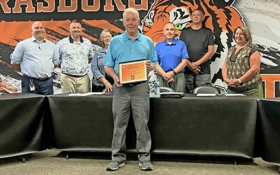 Al Osler, front, Tiger Way Award, back - Strasburg Superintendent Vince Lindsey, left, Jordan Boggs, Diana Flickinger, Kevin Harvey, Brent Miller, Marcha Clark, board members. Osler given the Tiger Way Award