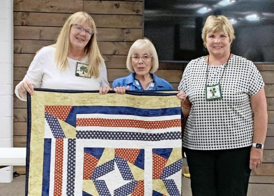 Members of the Wooster-Wayne DAR worked together to make this Quilt of Valor to be awarded to a veteran during the Honoring Our Patriots' Service ceremony. Lynne Smallstey, middle, and Jolene Dyer, right, presented the quilt to Jeri Fickes, left, Honoring Our Patriots' Service program co-chair, during the August meeting of the Tree City Quilters' Guild. HOPS program to honor veterans with quilts